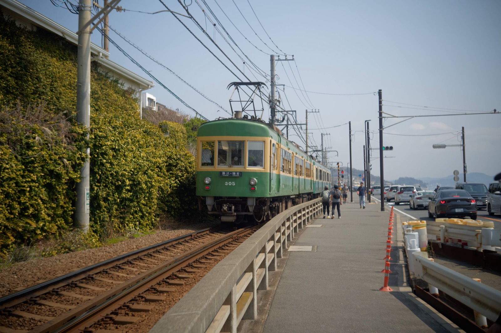 The Enoden train running along the street