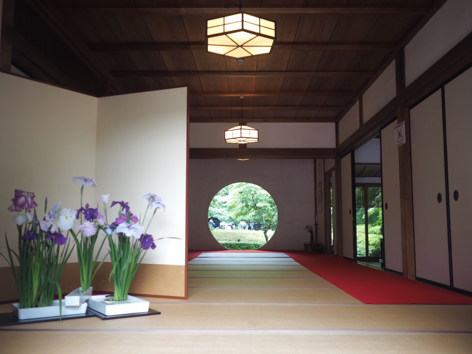 A round window in a temple room with irises